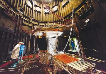  ?? NASA / JOHNS HOPKINS UNIVERSITY APPLIED PHYSICS LABORATORY VIA THE NEW YORK TIMES ?? Scientists inspect the solar array cooling system for the Parker Solar Probe spacecraft at NASA Goddard Space Flight Center in Greenbelt, Md. Launching in the summer of 2018, NASA’S Parker Solar Probe will become Earth’s first spacecraft to ever reach...