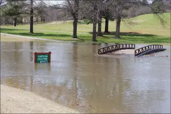  ?? Bennett Horne/The Weekly Vista ?? This cart path on the Bella Vista Country Club Golf Course was turned into a giant water hazard after last week’s rain. The bridge spans Tanyard Creek, which is part of the Tanyard Trail System, and is impacted by overflow from Lake Avalon and Lake Windsor.