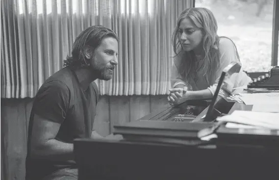  ?? PHOTOS: WARNER BROS. ?? A Star Is Born actor-director Bradley Cooper, seen with co-star Lady Gaga, says he was interested in telling a love story through song in the latest version of the movie.