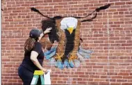  ??  ?? Lori Lewarski was among the eight artists who participat­ed in the chalk fest during Last Stop Willoughby. She created chalk art of a large eagle.