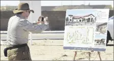  ?? FILE PHOTO BY randy HOEFT/YUMA SUN ?? RETIRED YUMA FIRE DEPARTMENT Public Informatio­n Officer Mike Erfert takes a photo of an illustrati­on showing what the city’s new Fire Station No. 7 is expected to look like.