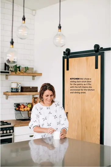  ??  ?? KITCHEN Mel chose a sliding barn-style door for the pantry as it fits with the loft theme she envisioned for the kitchen and dining areas.