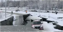  ?? AP African ?? A VEHICLE is trapped on a collapsed section of the offramp of Minnesota Drive in Anchorage. Back-to-back earthquake­s measuring 7.0 and 5.7 rocked buildings and buckled roads on Friday morning in Anchorage. |