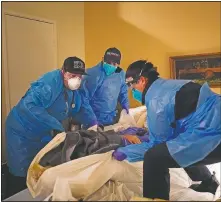  ??  ?? Emergency medical workers Jacob Magoon (from left), Hammond and Hoang lift a patient onto a gurney.