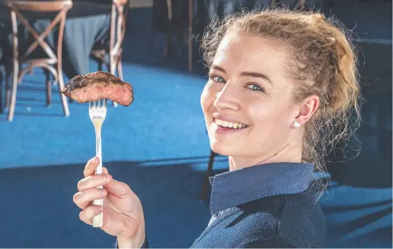  ?? Picture: Nev Madsen. ?? DIG IN: Mort and Co’s Sarah Patterson tries the Pheonix Wagyu Striploin at the 2021 Darling Downs Beef Battle launch.