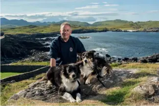  ??  ?? Left: One man and his dogs. Visitors to the lighthouse love meeting Peggy and Ted. Below: Most visitors choose to climb the tower, which provides an excellent aerial viewpoint for spotting basking sharks and marine mammals.