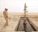  ??  ?? A worker walks past the oil well at the Sindbad oil field near the Iraqi-iranian border in Basra. — Reuters