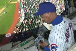  ??  ?? Ronnie ‘‘ Woo Woo’’ Wickers realized a dream when he sang ‘‘ Take Me Out to the Ballgame’’ at Wrigley Field in 2001, but he was removed from the ballpark on April 19 because he could not produce an e- ticket.
| SUN- TIMES FILES