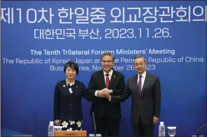  ?? (AP/Ahn Young-joon) ?? Chinese Foreign Minister Wang Yi (right), South Korean Foreign Minister Park Jin (center) and Japanese Foreign Minister Yoko Kamikawa pose for a photo prior to the trilateral foreign ministers’ meeting in Busan, South Korea, on Sunday.