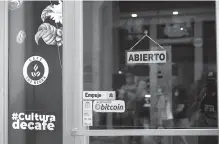 ?? Reuters-Yonhap ?? A sign reads “Bitcoin accepted here” outside a coffee shop where the cryptocurr­ency is accepted as a payment method in San Salvador in this May 15 file photo.