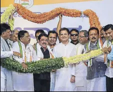  ?? PTI ?? Congress president Rahul Gandhi poses with newly inducted members from Janta Dal (S) during a rally in Mysuru on Sunday.