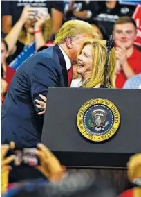  ?? PHOTO BY MICHAEL PATRICK/KNOXVILLE NEWS SENTINEL ?? President Donald Trump gives a kiss to Marsha Blackburn after his speech at his Make America Great Again rally Monday in Johnson City, Tenn.