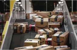  ?? Victor J. Blue / Bloomberg ?? Packages move along a conveyer belt at the Amazon.com fulfillmen­t center in Robbinsvil­le, N.J. The online shift was noticeable before Cyber Monday.