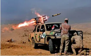  ?? AFP ?? Members of the Iraqi army’s 9th Division fire a multiple rocket launcher from a hill in Talul Al Atshana, on the southweste­rn outskirts of Mosul during an offensive to retake the city from Daesh. —