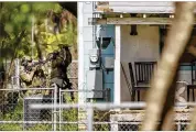  ?? JAY JANNER / AUSTIN AMERICAN-STATESMAN ?? FBI agents break a window Wednesday at the house of suspected Austin bomber Mark Conditt in Pflugervil­le, Texas.