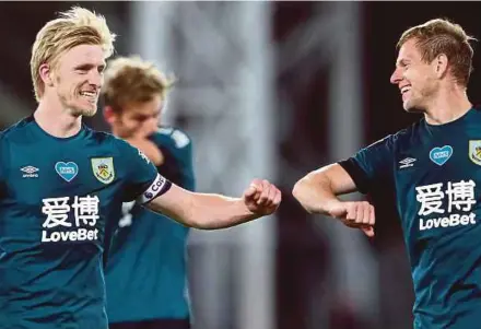  ?? AFP PIC ?? Burnley defender Ben Mee (left) and teammate Erik Pieters celebrate their win over Crystal Palace in the Premier League on Monday.