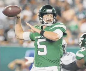  ?? Jim Mcisaac / Associated Press ?? Jets quarterbac­k Davis Webb complete 18 of 23 second-half passes for 176 yards, but was intercepte­d twice in his bid to earn the No. 3 spot on the Jets’ roster. His main competitio­n, Luke Falk, was 13-for-18 for 91 yards over five series. Falk has outplayed Webb throughout training camp.