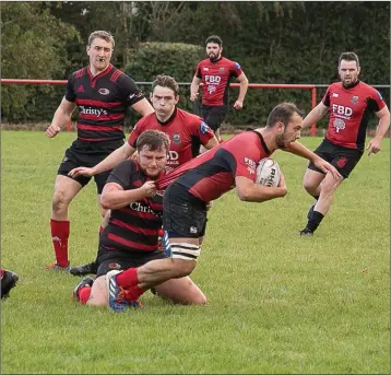  ??  ?? Arklow’s Gavin Cox wasn’t letting go of his man during the Leinster League Division 2B clash.