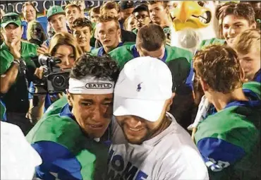  ?? MARC PENDLETON / STAFF ?? Chaminade Julienne quarterbac­k Ryan Minor (left) celebrated a 58-16 Week 3 defeat of Greenville with a surprise visit from his father, Chris Minor, a U.S. Air Force captain deployed in Turkey.