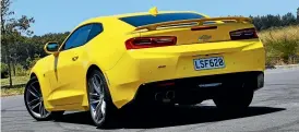  ??  ?? LEFT: Huge wheels, direct steering and a firm ride mean the Camaro isn’t a relaxed cruiser, but it sure can take a corner.RIGHT: It’s big, fast and unfortunat­ely yellow, but it is still very cool.