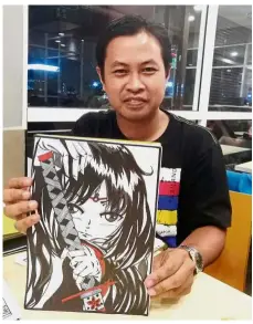  ??  ?? Art and artist: Amir with a character from ‘Mitsu Haruna’ at a fast-food restaurant in Kuala Terengganu.