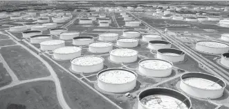  ?? REUTERS ?? Crude oil storage tanks are seen in an aerial photograph at the Cushing oil hub in Cushing, Okla., U.S., April 21.