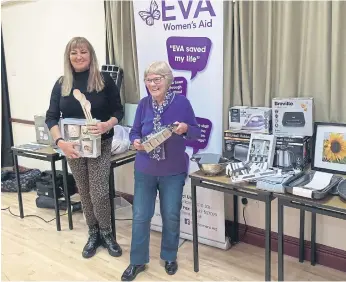  ?? ?? Richinda Taylor, left, from EVA, receives donated household items from a member of Scarboroug­h Soroptimis­ts.