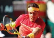  ?? ALBERTO SAIZ - THE ASSOCIATED PRESS ?? FILE - In this Sunday April 8, 2018 file photo, Spain’s Rafael Nadal returns the ball to Germany’s Alexander Zverev during a World Group quarterfin­al Davis Cup tennis match between Spain and Germany at the bullring in Valencia, Spain.