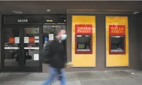  ?? Lea Suzuki / The Chronicle ?? A pedestrian walks past a shuttered Wells Fargo branch on 24th Street in S.F.