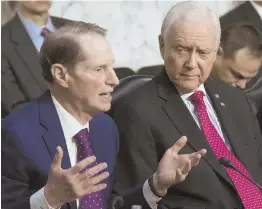  ?? AP PHOTO ?? TAXING ISSUES: U.S. Sen. Ron Wyden (D-Ore.), left, criticizes the Republican-sponsored tax reform plan yesterday while Sen. Orrin Hatch (R-Utah) listens during a Senate Finance Committee hearing.