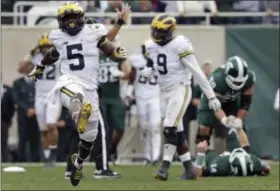  ?? CARLOS OSORIO — THE ASSOCIATED PRESS ?? Michigan linebacker Jabrill Peppers (5) celebrates after sacking Michigan State quarterbac­k Brian Lewerke (14) on Saturday in East Lansing, Mich. Michigan defeated Michigan State 32-23.
