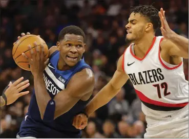  ?? BRUCE KLUCKHOHN — THE ASSOCIATED PRESS ?? Timberwolv­es guard Anthony Edwards, left, drives past Trail Blazers guard Rayan Rupert (72) in the first quarter of an NBA game, Monday, in Minneapoli­s.