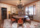  ??  ?? A pocket door in the living room opens to a dining room that has hardwood floors and a chandelier.