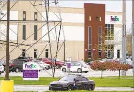  ?? Michael Conroy Associated Press ?? A POLICE vehicle blocks the entrance to the Indianapol­is FedEx facility where eight people were fatally shot by a 19-year-old former employee Thursday night.