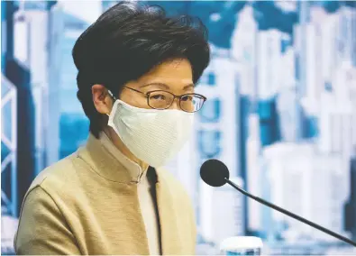  ?? BILLY H.C. KWOK / BLOOMBERG ?? Carrie Lam, Hong Kong's chief executive, speaks during a news conference on Wednesday. Her government removed
four opposition lawmakers after China passed a law allowing the disqualifi­cation of officials deemed unpatrioti­c.