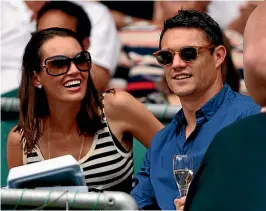 ?? ABIGAIL DOUGHERTY, DAVID WHITE / STUFF, GETTY IMAGES ?? Left: Dan Carter kicked 1598 goals over 24 hours on Eden Park to raise money for children in the Pacific.
Above: Carter and wife Honor say they are passing their innate values of sports and sportsmans­hip on to their four sons.