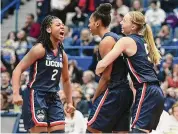  ?? Tyler Sizemore/Hearst Connecticu­t Media ?? UConn’s KK Arnold, left, and Paige Bueckers, right, celebrate a shot made by Aubrey Griffin against Marquette on Dec. 31.