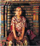  ??  ?? Childish torment: Sajani Shakya, aged 9, is worshipped as a living goddess