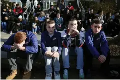  ?? Associated Press ?? ■ Somerville High School students sit on the sidewalk Feb. 28 on Highland Avenue during a student walkout at the school in Somerville, Mass. A largescale, coordinate­d demonstrat­ion is planned for Wednesday, when organizers have called for a 17-minute...