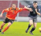  ??  ?? Battle for possession Defender Adam Cummins tussles with Blues man Pic: Ian Cairns