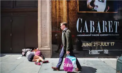  ?? Photograph: Gabrielle Lurie/The Guardian ?? A man walks by a homeless woman on the sidewalk, in the Tenderloin District of San Francisco, California, on 14 June 2016.