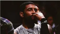  ?? Dustin Satloff / TNS ?? Kyrie Irving of the Brooklyn Nets looks on from the bench during a game against the Bulls.