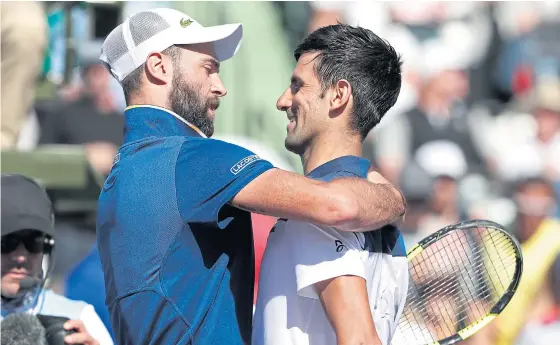  ??  ?? Benoit Paire, left, is congratula­ted by Novak Djokovic after their match.