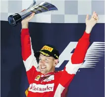  ?? NG HAN GUAN/THE ASSOCIATED PRESS ?? Ferrari driver Sebastian Vettel celebrates after winning the Singapore Formula One Grand Prix on Sunday.