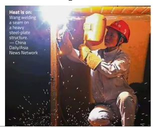  ??  ?? Heat is on: Wang welding a seam on a heavy steel-plate structure. — China Daily/Asia News Network