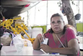  ??  ?? Adriana Estrada Acosta, living in a tent after her apartment complex was seriously damaged during the Sept. 19 earthquake, talks Friday about her living situation.