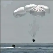  ?? NASA TV ?? In this frame grab from NASA TV, the SpaceX capsule splashes down Sunday in the Gulf of Mexico. Astronauts Doug Hurley and Bob Behnken spent a little over two months on the Internatio­nal Space Station.
