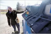  ?? LUIS SÁNCHEZ SATURNO/THE NEW MEXICAN ?? Frederick Turner deposits glass Wednesday at the recycling drop-off center behind Fort Marcy Ballpark. A divided panel of city councilors on Wednesday punted on whether to close Santa Fe’s busiest dropoff center.