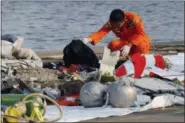  ?? TATAN SYUFLANA — THE ASSOCIATED PRESS ?? A member of Indonesian Search and Rescue Agency (BASARNAS) inspects debris believed to be from Lion Air passenger jet that crashed Monday off Java Island at Tanjung Priok Port in Jakarta, Indonesia.