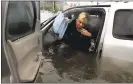  ?? LM OTERO — ASSOCIATED PRESS ?? A woman steps out of her car into water.